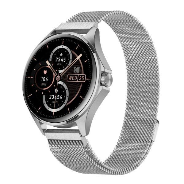 El Reloj Smart Watch SW-7212 de Kodak es un reloj inteligente con muchas funciones, incluyendo:

Pantalla:
- Pantalla táctil HD de 1.32"
- Resolución de 466 x 466 píxeles

Seguimiento de Salud y Estado Físico:
- Monitoreo de salud 24/7 (Frecuencia Cardíaca, Oxígeno en Sangre - SpO2, Presión Arterial, Prueba de Estrés)
- Más de 100 modos deportivos con seguimiento de movimiento a través del GPS del móvil
- Podómetro
- Monitoreo del sueño

Funciones Inteligentes:
- Llamadas por Bluetooth y soporte de Asistente de Voz (BT 5.0 + BT 3.0)
- Notificaciones de Mensajes
- Control de Cámara
- Control de Música
- Función "Encontrar Teléfono"
- Reloj Mundial, Alarma, Cronómetro, Temporizador
- Actualizaciones del Clima
- Calculadora, Calendario, Recordatorios
- Firmware multi-idioma
- Múltiples carátulas de reloj (10 preinstaladas + opciones personalizables)

Diseño y Construcción:
- Botón de navegación con corona giratoria
- Material de la Caja: Aleación de Zinc
- Material de la Correa: Acero Inoxidable
- Resistencia al Agua: IP67

Batería:
- Capacidad de la batería: 260mAh
- Tiempo de funcionamiento: Hasta 5 días
- Tiempo en espera: Aproximadamente 10 días
- Tiempo de carga: Alrededor de 3 horas
- Método de carga: Carga Inalámbrica / Carga Magnética

Conectividad y Compatibilidad:
- Bluetooth: BT 5.0 + BT 3.0
- Compatible con Android e iOS

Otras Funciones:
- Micrófono y Altavoz Incorporados
- GPS (a través del móvil)

En la Caja:
- Kodak Smartwatch SW-7212
- Base de carga
- Paño de limpieza
- Manual de usuario